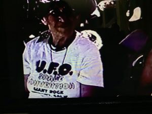 Video capture of a woman wearing a UFO convention t-shirt in the 1970s